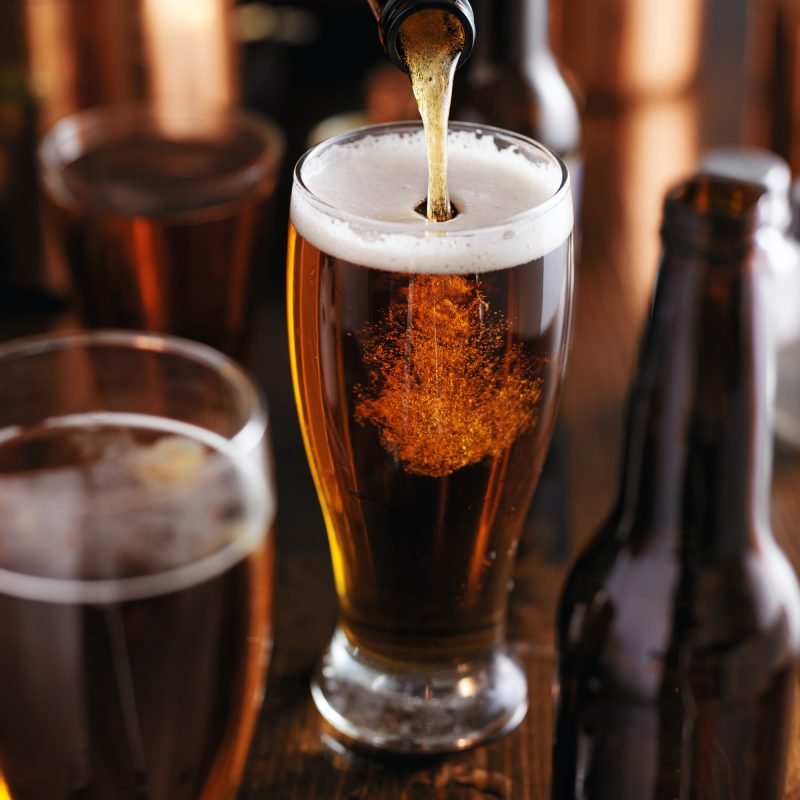 pourng-beer-from-bottle-into-glass-at-bar.jpg